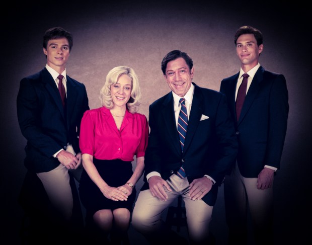 a family posing for a picture with two boys and a woman