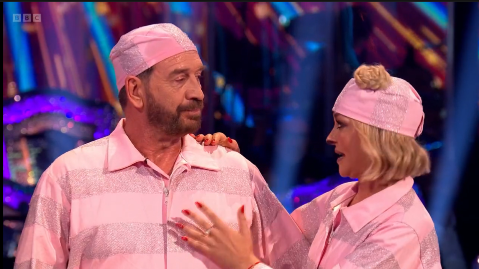 a man and a woman are wearing pink pajamas and hats