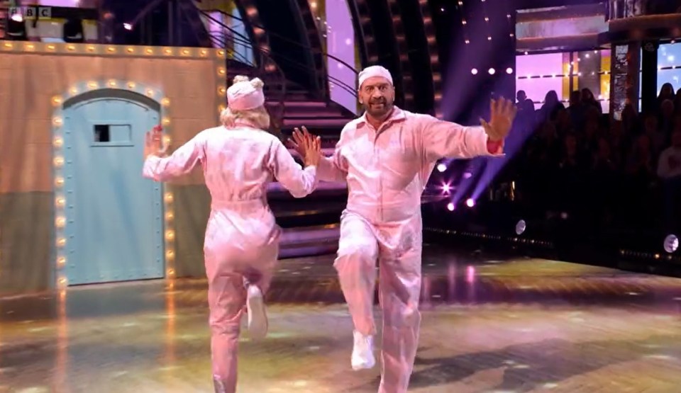 a man and a woman are dancing on a stage with bbc in the background