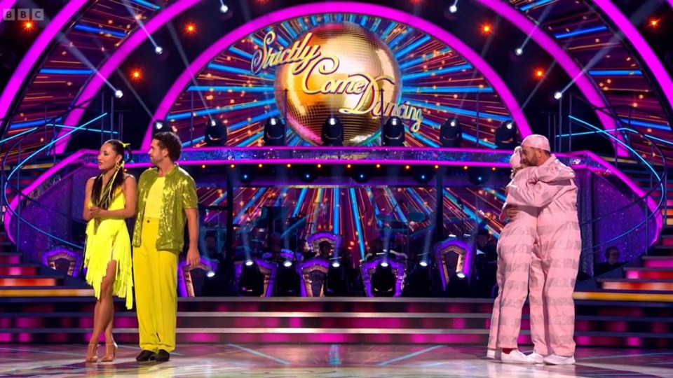 a group of people on a stage in front of a ball that says strictly come dancing