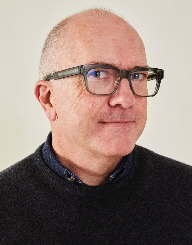 a bald man wearing glasses and a black sweater