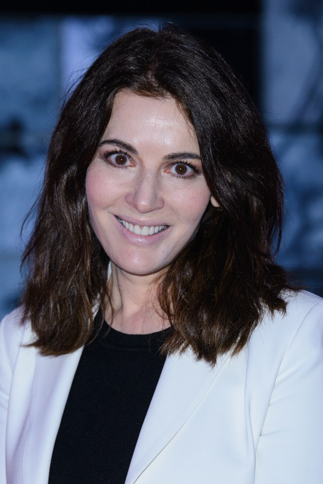 a woman with dark hair and a white jacket smiles for the camera