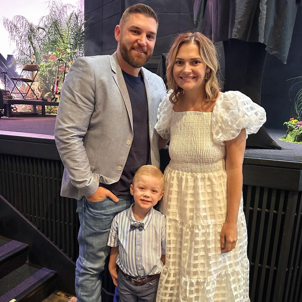 a family posing for a picture in front of a stage