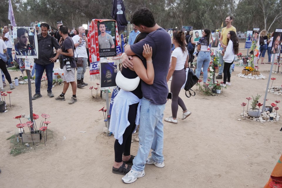 Two grief-stricken people hug