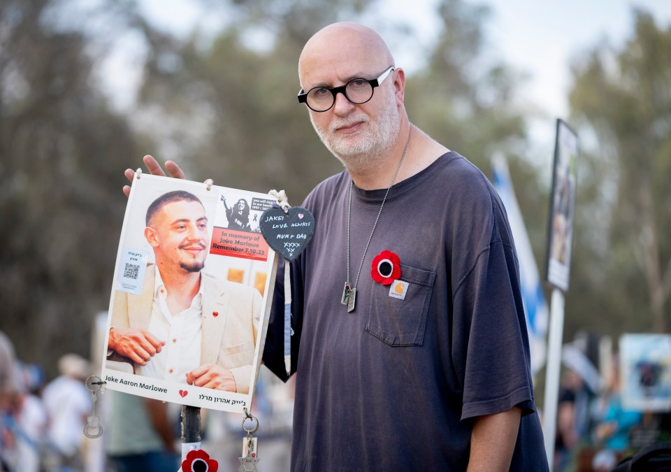 Jake's dad Michael, here with a picture of his son at the Nova memorial in Israel, is consumed by rage towards his son’s savage killers