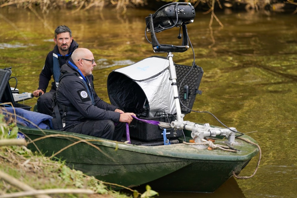 a man sitting in a boat with a purple rope tied to it