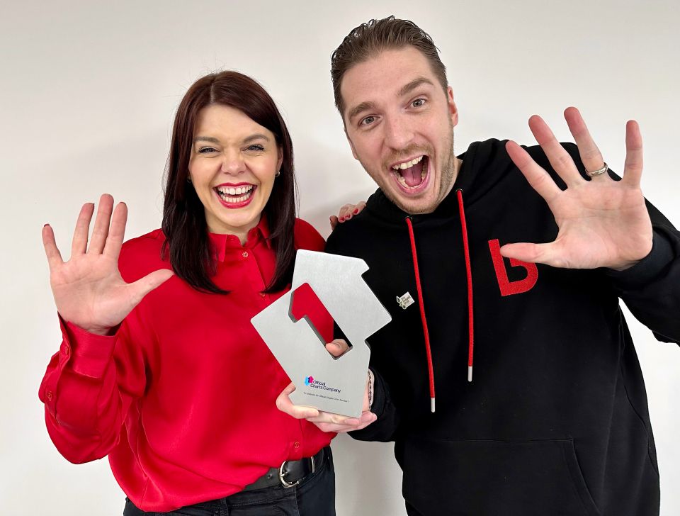 a man and a woman are holding a trophy that says ' live discovery ' on it