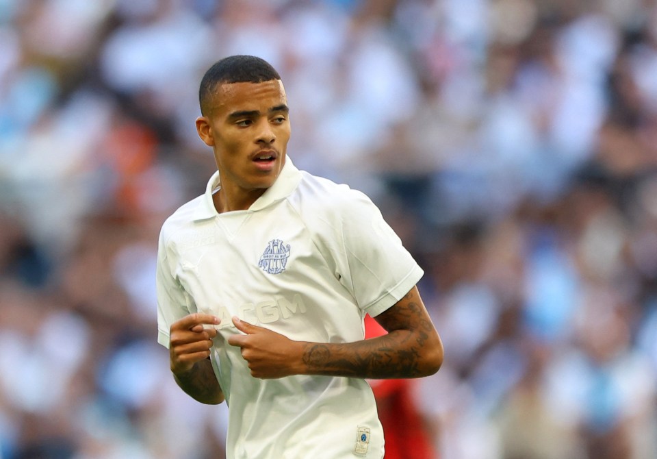 a soccer player wearing a white shirt with the word gm on it