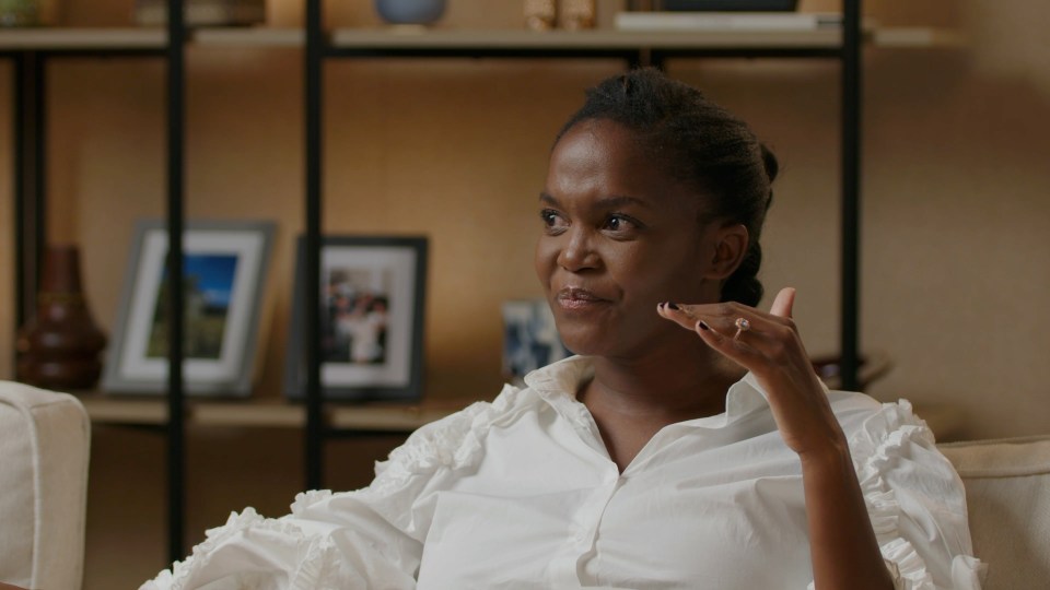 a woman in a white shirt is sitting on a couch