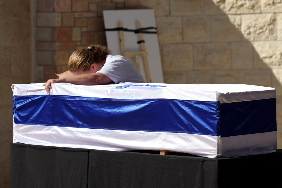 Her heartbroken mum Adi Marciano sobs over her coffin at her funeral