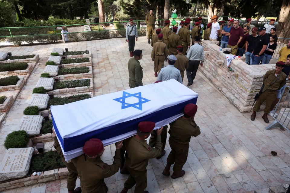 soldiers carry a coffin with a star of david on it