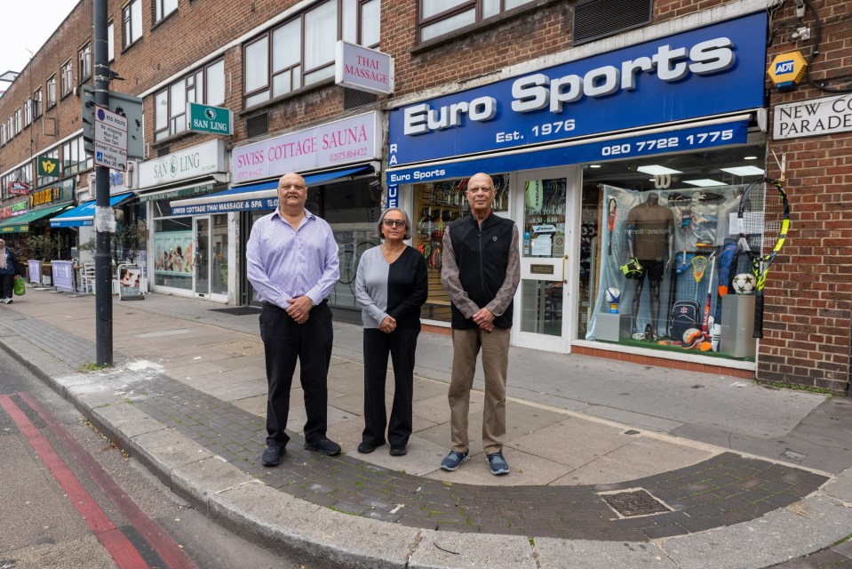 three people stand in front of a euro sports store