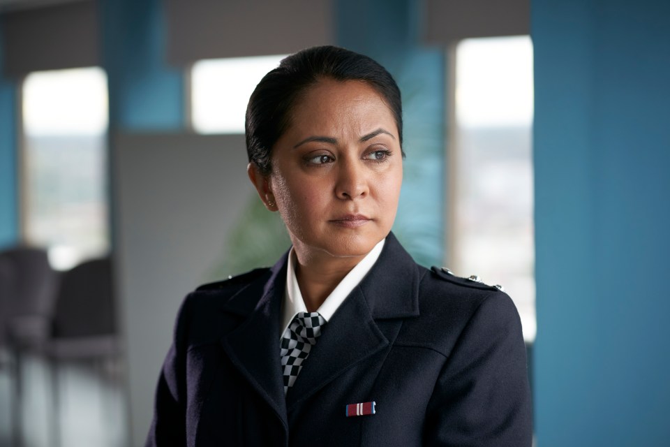 a woman in a police uniform has a medal on her collar