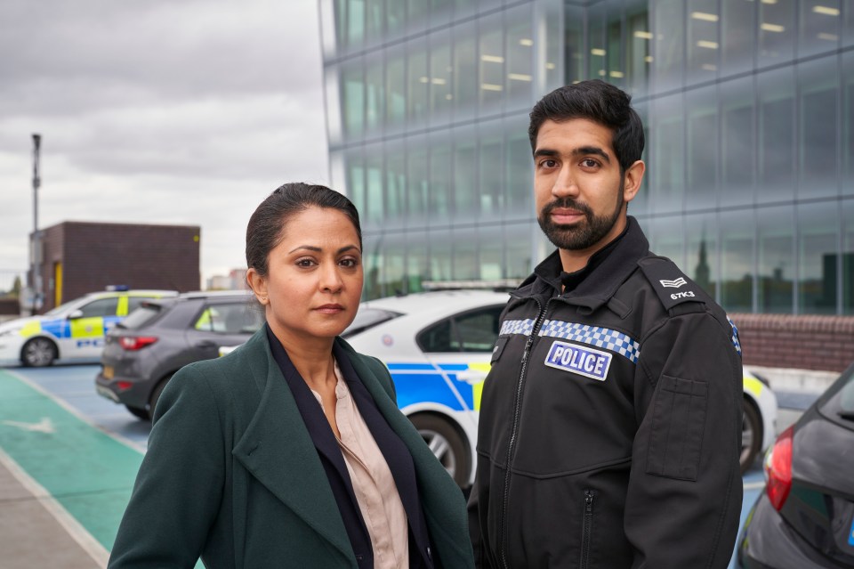 a man in a police uniform stands next to a woman