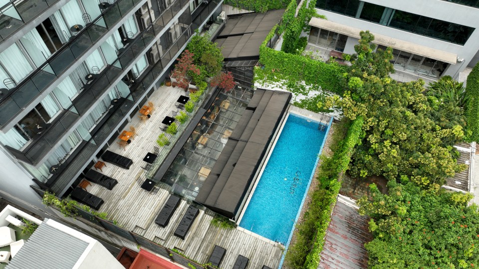 an aerial view of a swimming pool surrounded by buildings