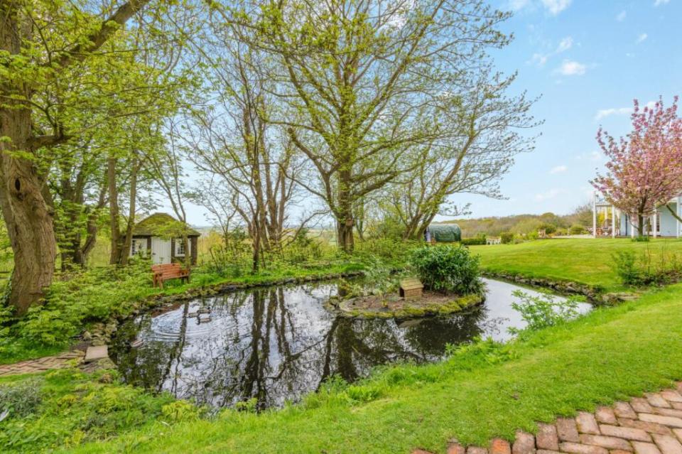 The outdoor area features an orchard and paddocks