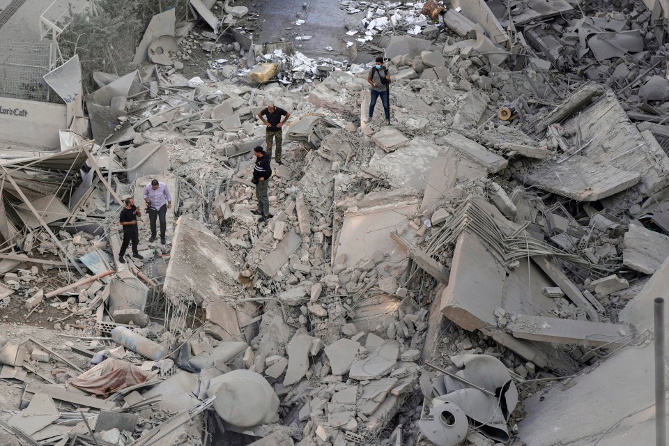 People check the site of an Israeli airstrike in Dahiyeh, Beirut