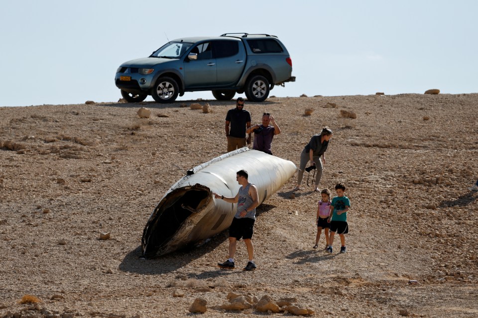 a group of people standing in front of a mitsubishi truck