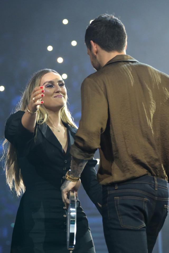 a man and a woman are standing next to each other on a stage