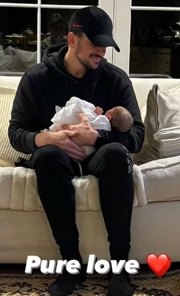 a man sitting on a couch holding a baby with the words pure love below him