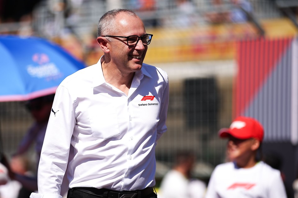 a man wearing glasses and a white shirt that says ' stefano ferrari ' on it