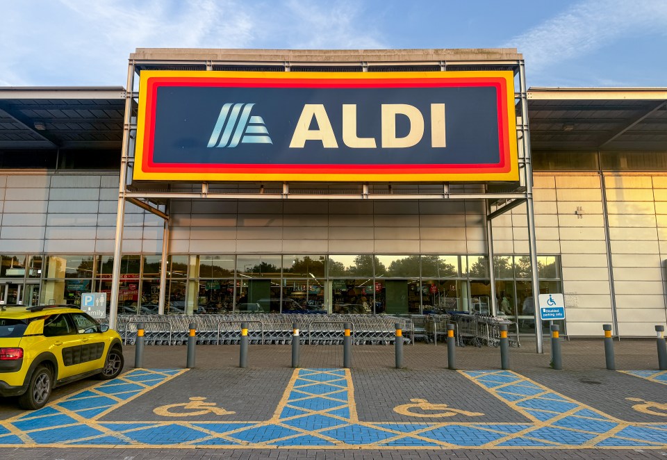 a car is parked in front of an aldi store