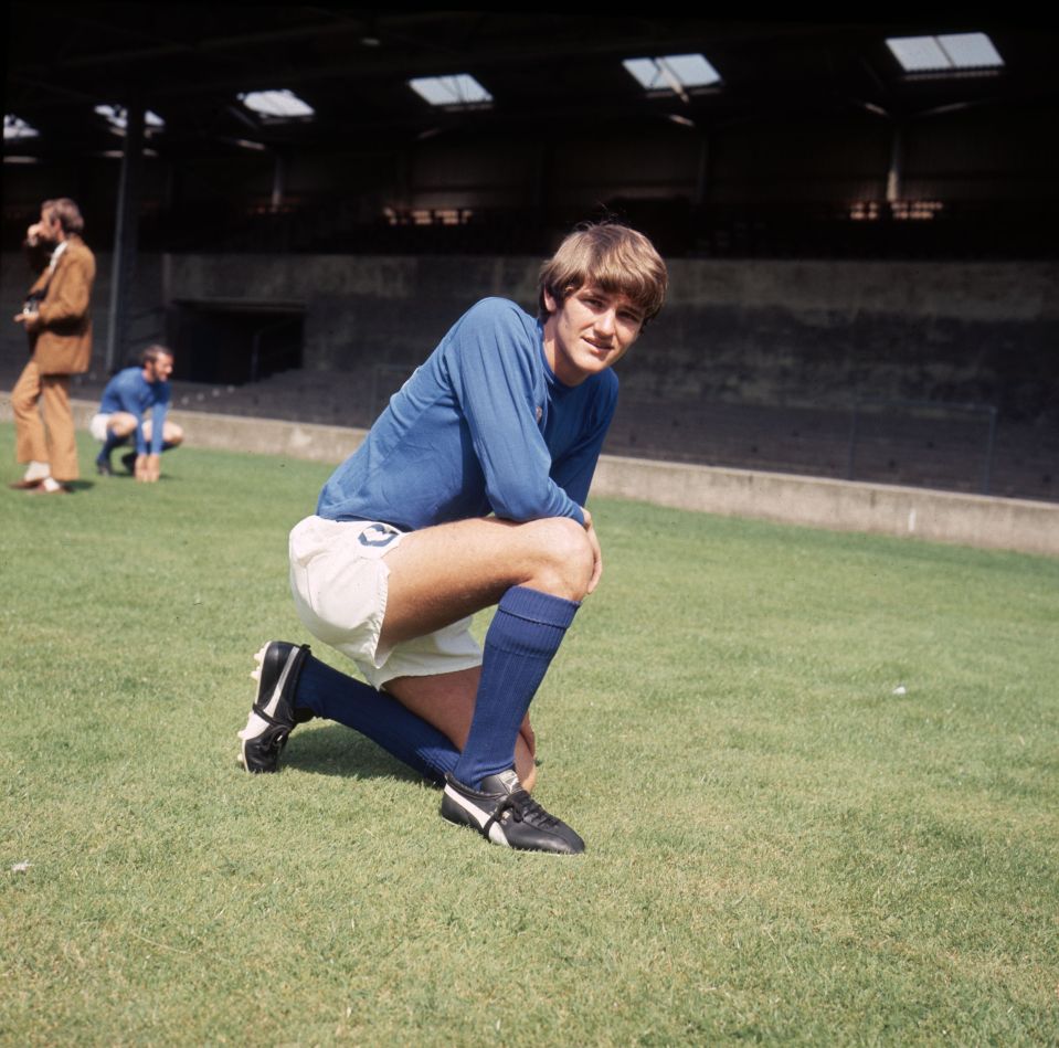 a man in a blue shirt with the number 12 on it