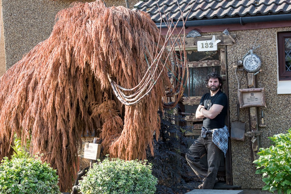 The artist fashioned a woolly mammoth out of recycled wood