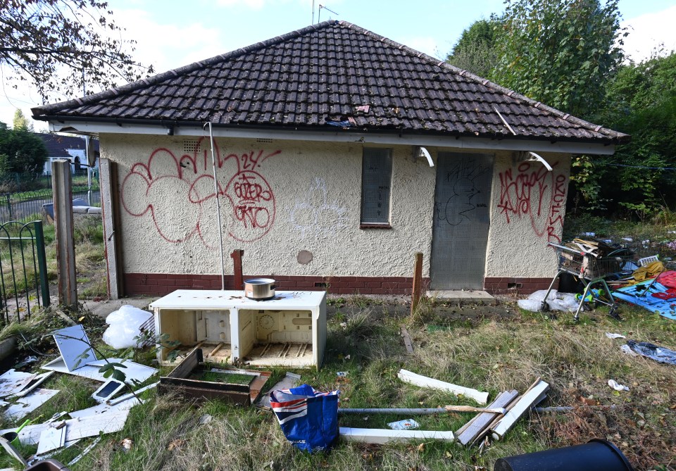 a house with graffiti on the walls including one that says " i love you "