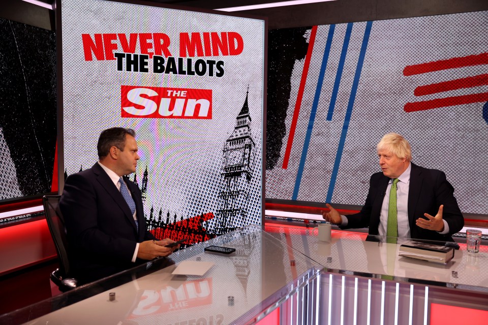 two men are sitting in front of a screen that says never mind the ballots