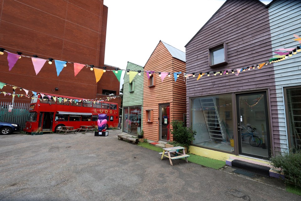 The bus is located on a regenerated yard which features additional shops