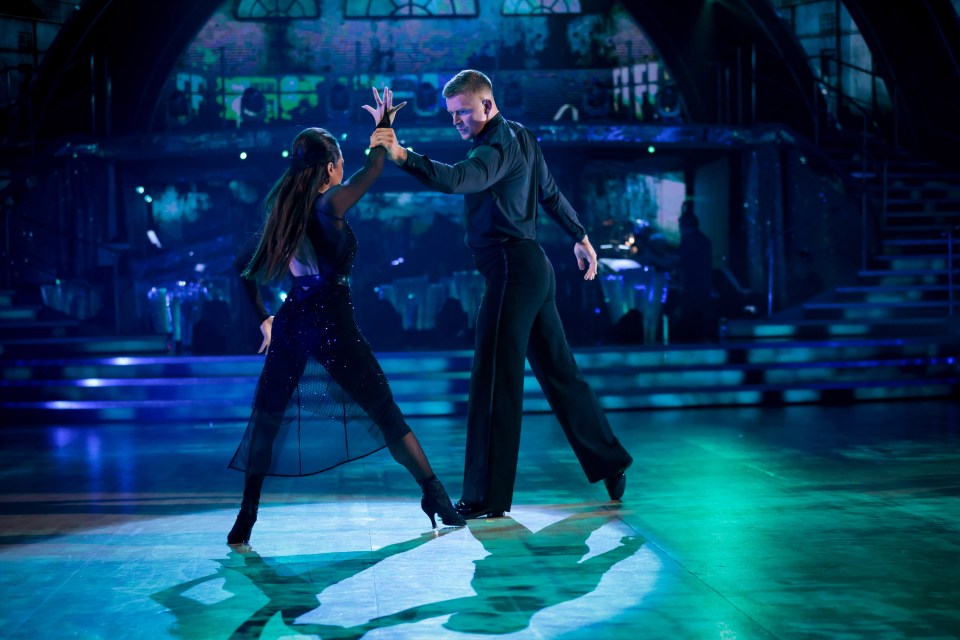 a man and a woman are dancing on a stage with the word tiff in the background