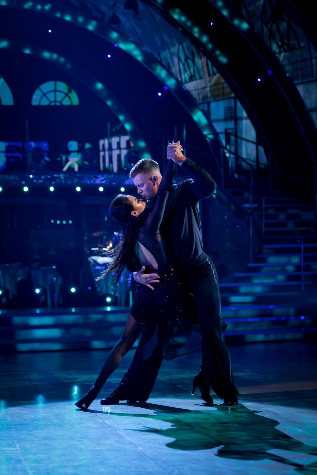 a man and a woman are dancing on a stage with the word tiff in the background