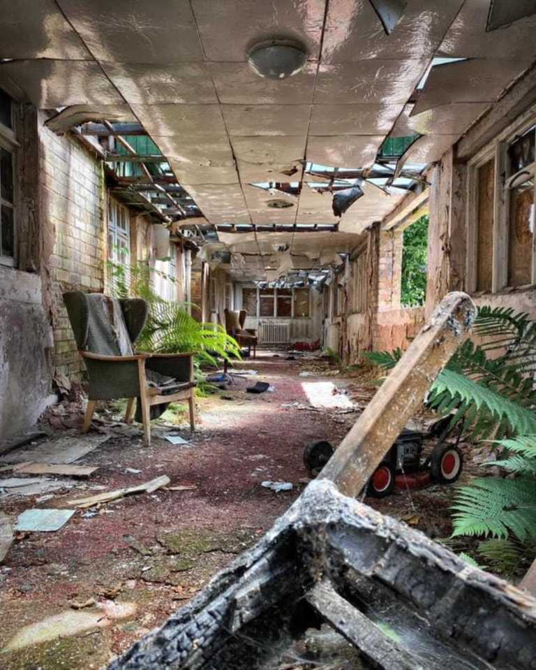 an abandoned building with a lawn mower in the middle