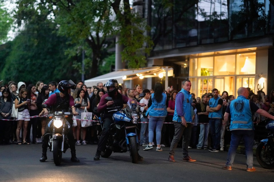 Crowds have gathered behind a police cordon outside the Buenos Aires hotel