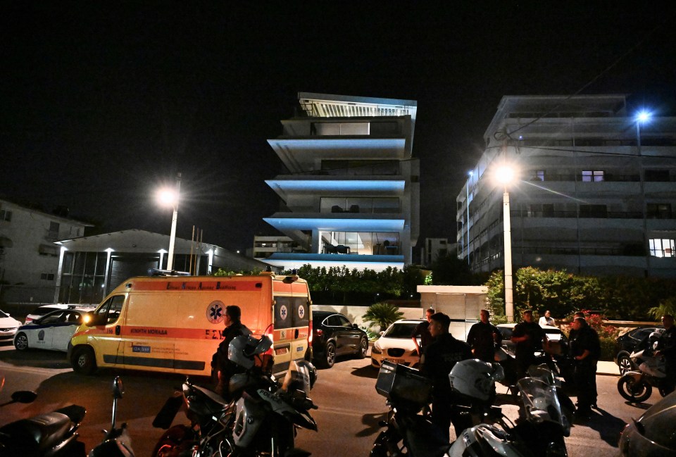 an ambulance is parked in front of a building at night