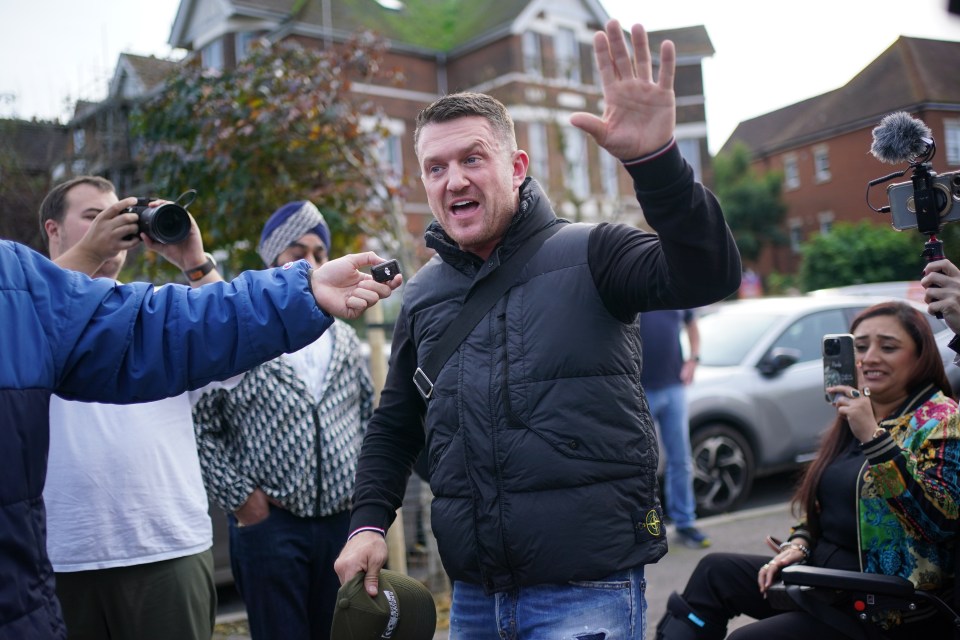 a man in a black vest with the word stone island on it