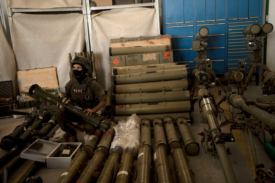 An Israeli soldier from an EOD (explosive ordnance disposal) poses with the seized weapons