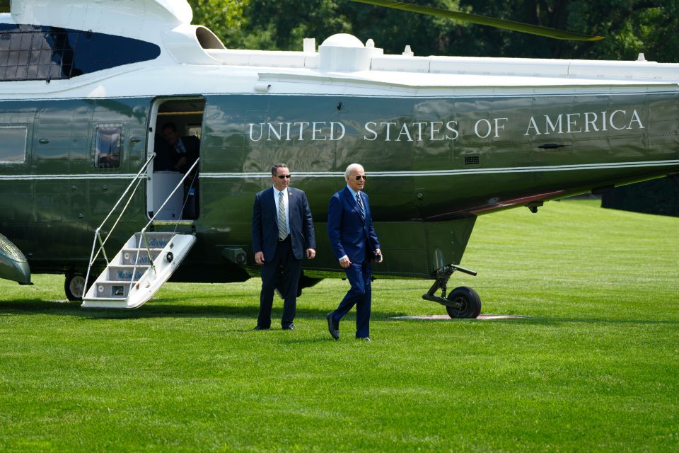 Joe Biden followed closely by one of his security guards