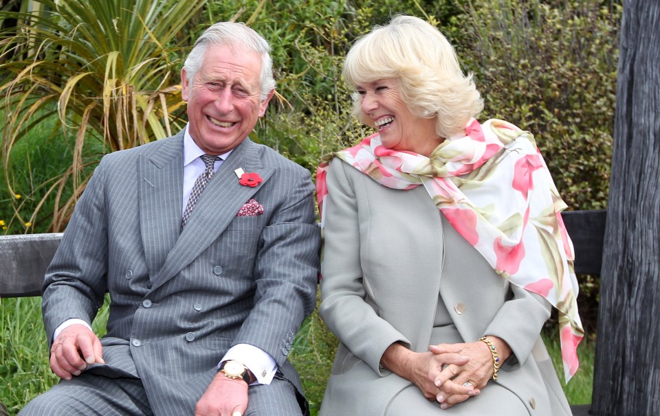 a man and a woman are sitting next to each other and smiling