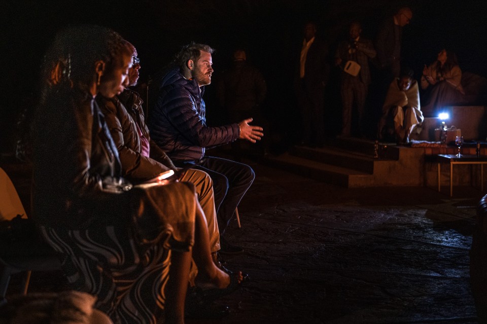 a group of people are sitting in a dark room