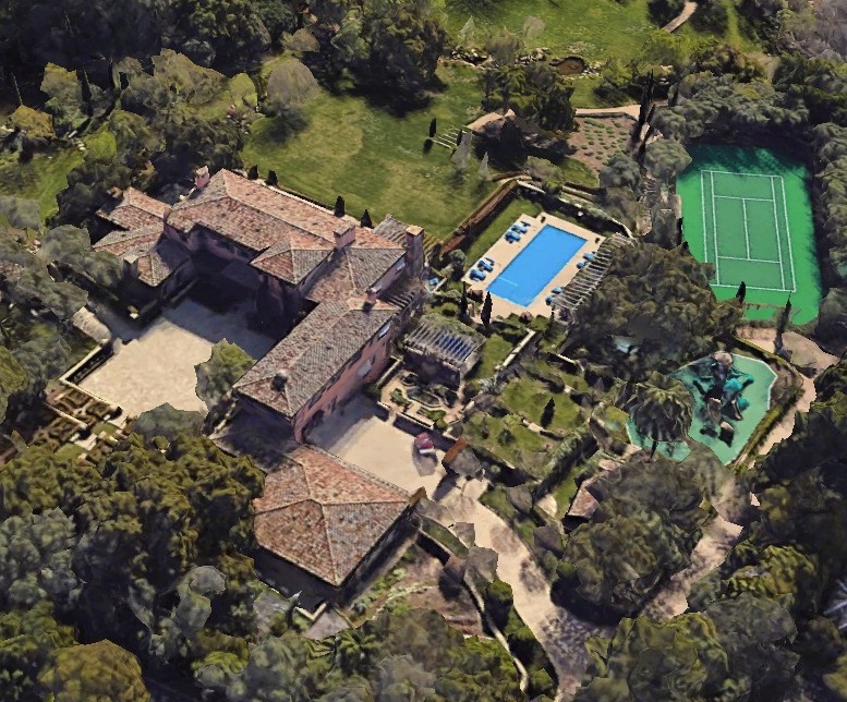 an aerial view of a large house with a swimming pool and tennis court