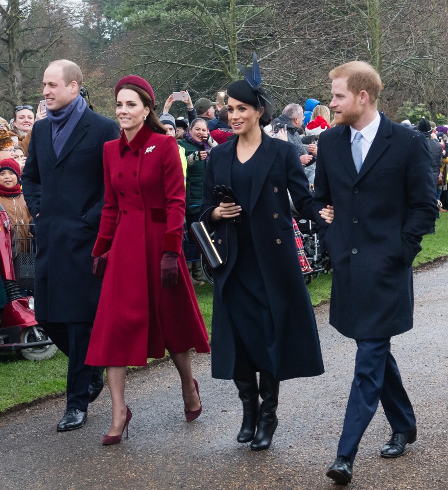 a group of people are walking down a street and one of them is wearing a red coat