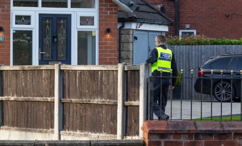 a man wearing a vest that says police on it