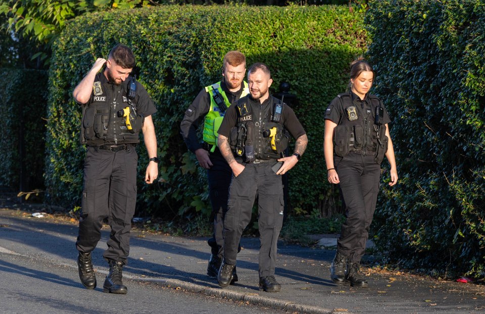 a group of police officers are walking down a street