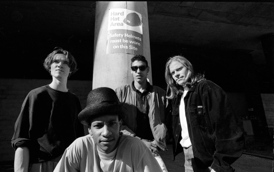 a group of men standing in front of a sign that says hard hat area