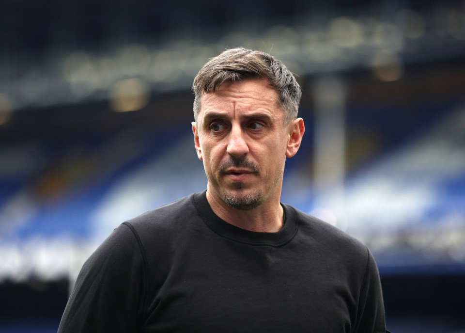 a man in a black shirt stands in front of a blue and white stadium