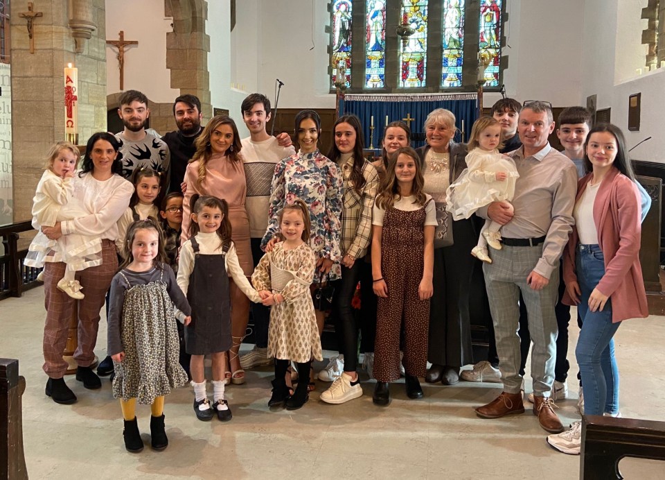 a large family posing for a picture in a church