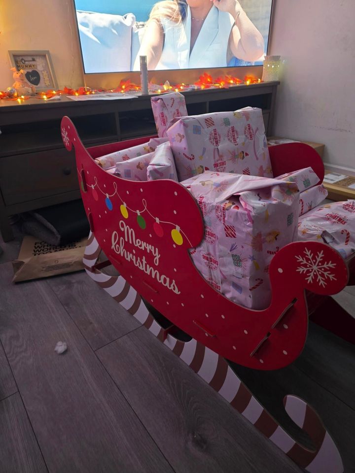 a red sleigh with merry christmas written on it