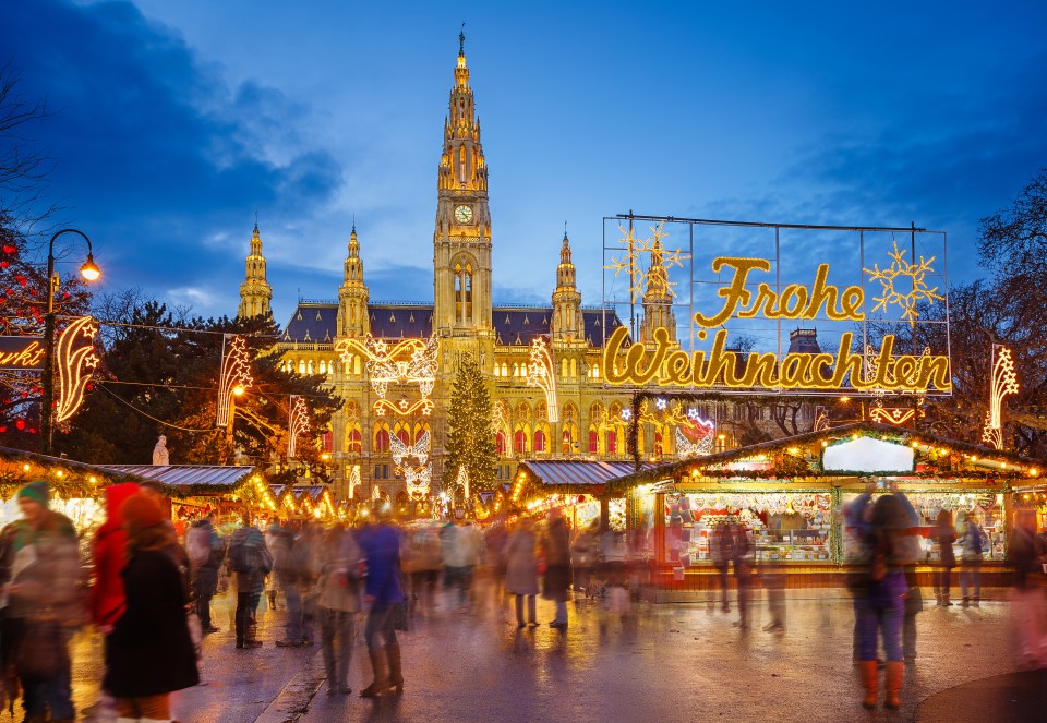 a christmas market with a sign that says frohe weihnachten